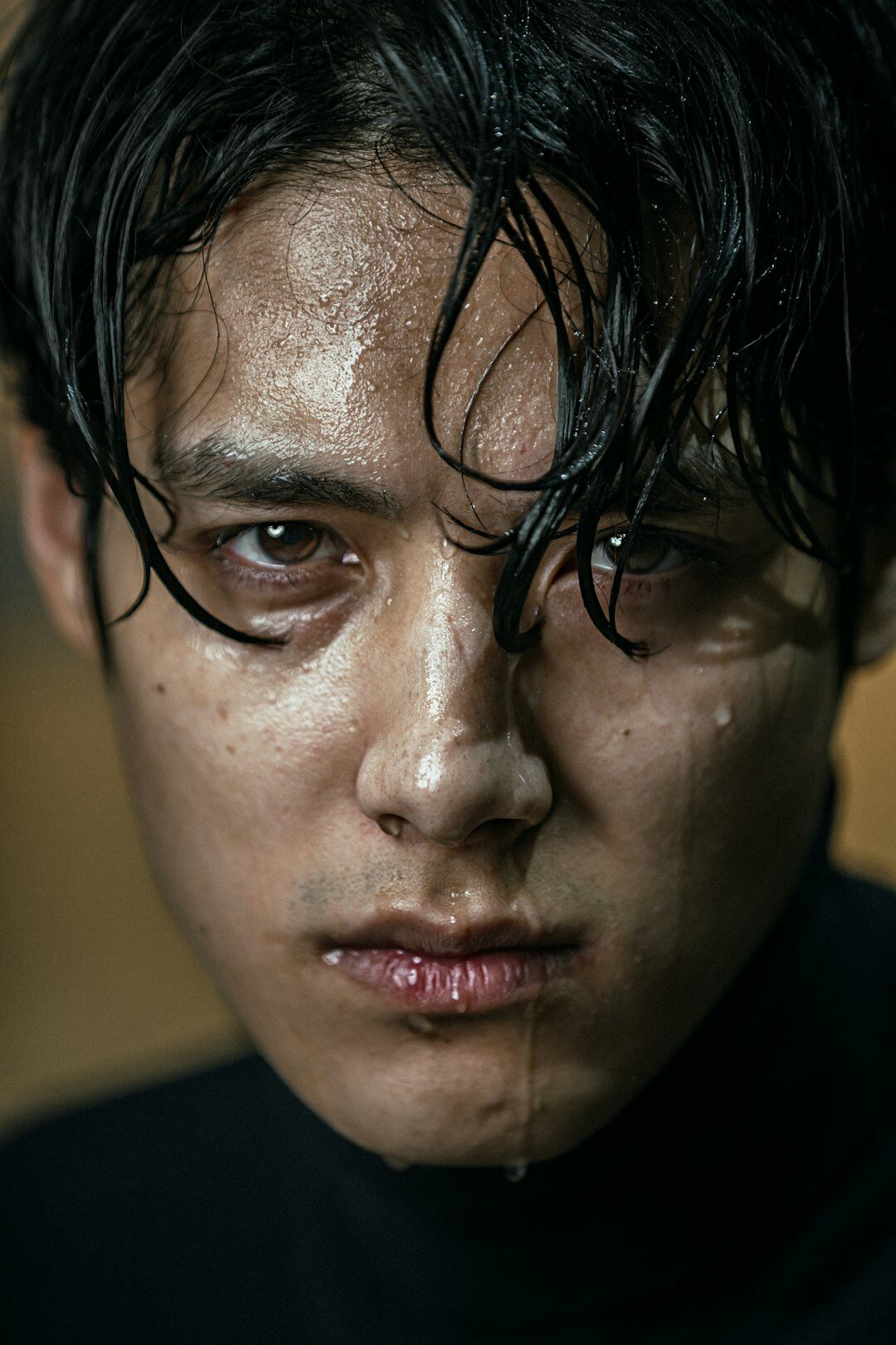 Studio portrait of a Japanese male actor in a tailored dark suit