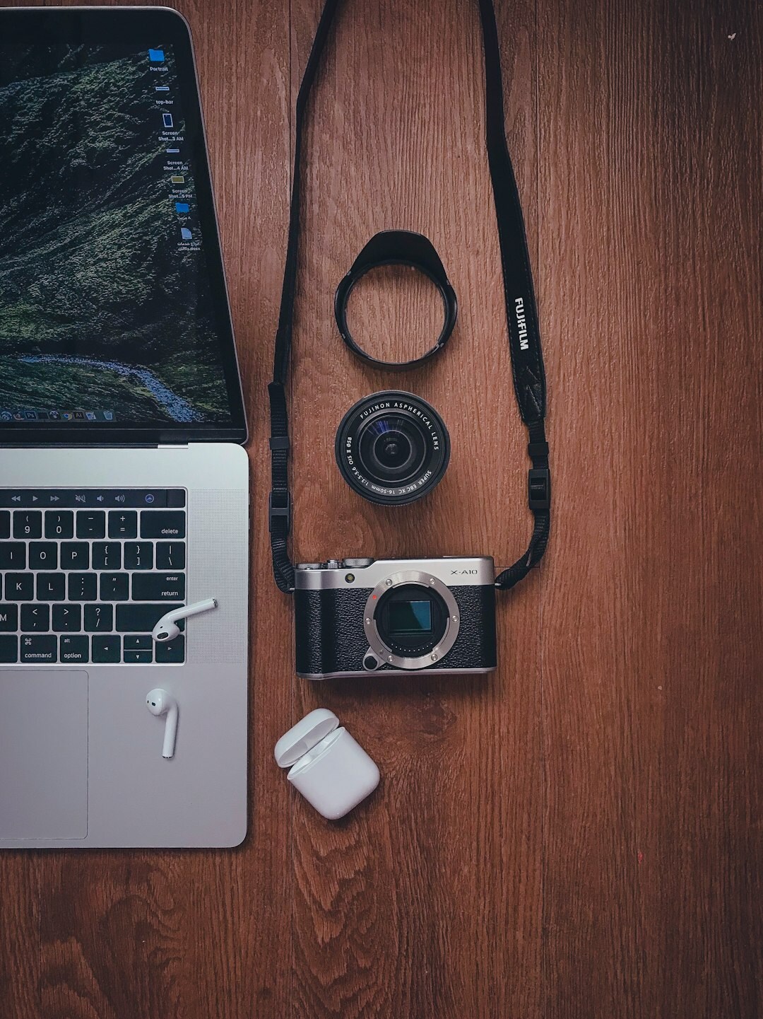 Editor's desk with camera, notebook and laptop preparing a travel article